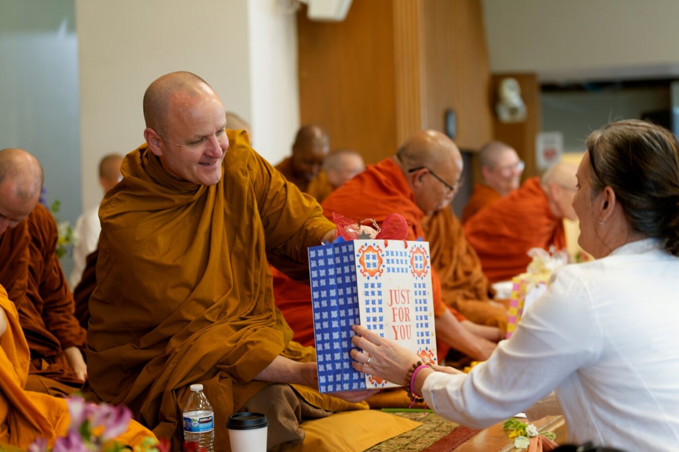 Ajahn Sudanto accepts a gift during the Almsgiving Ceremony